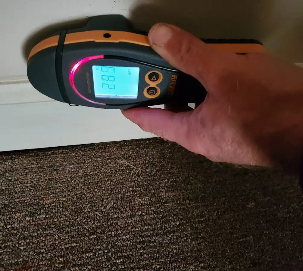 Moisture detection at baseboard during Storm Damage Restoration in Carolina Forest